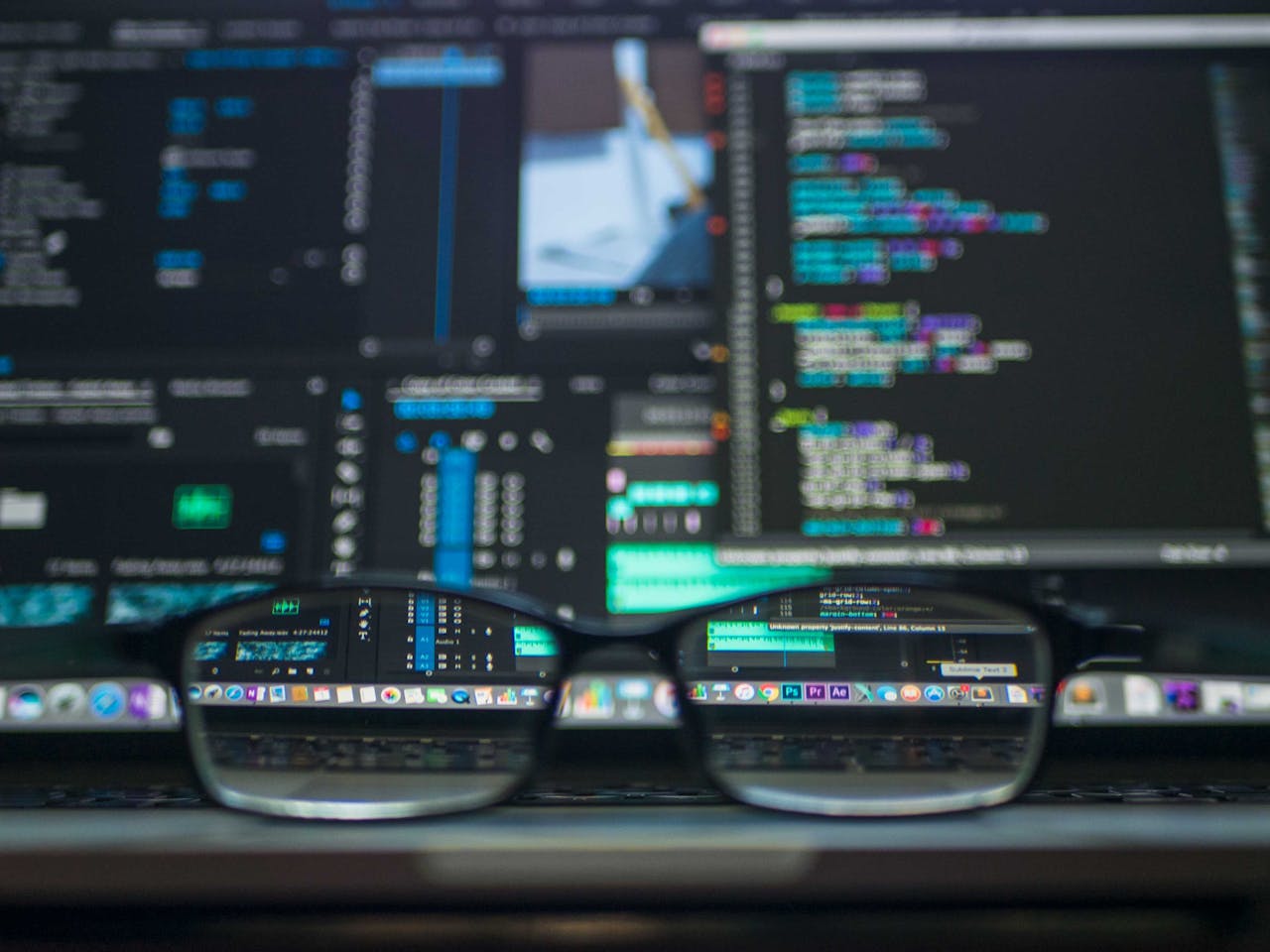 Eyeglasses reflecting computer code on a monitor, ideal for technology and programming themes max-it-development.com